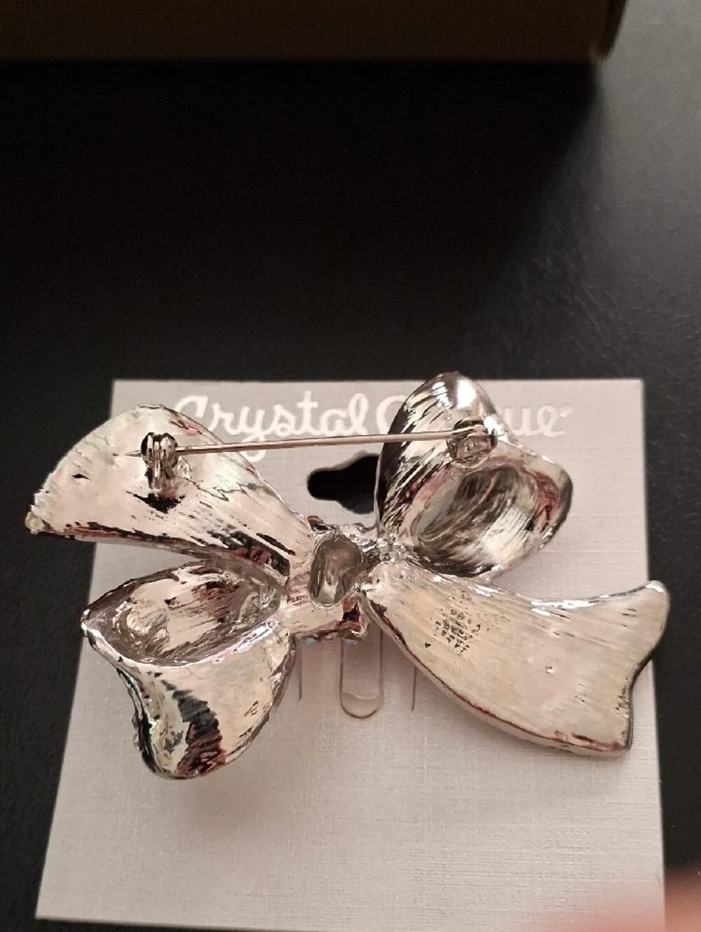 Crystal-Embellished Silver Bow Pin with Iridescent Center